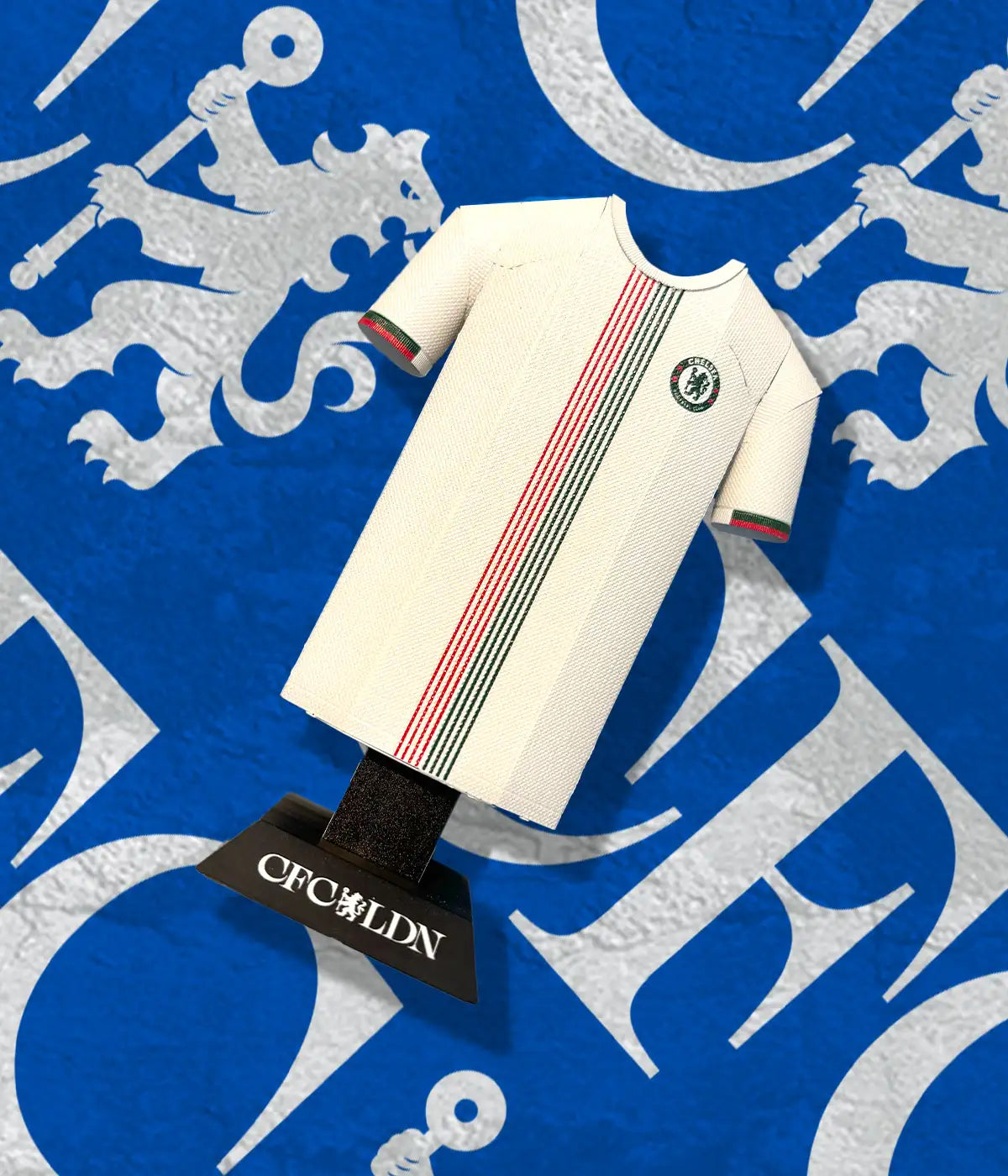 White sports jersey with red and green stripes on a blue background with a logo.