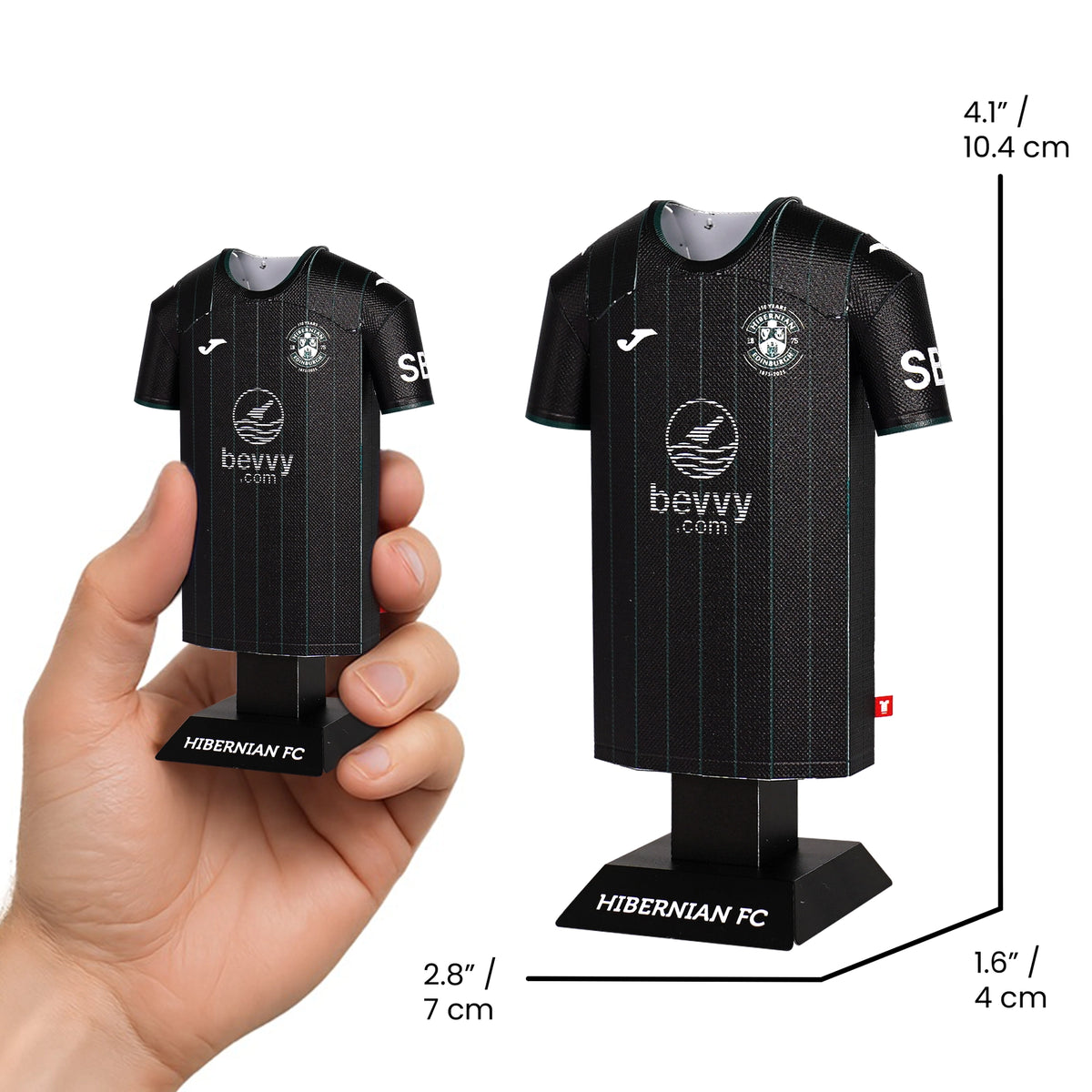 Hibernian FC mini soccer jersey on a stand with measurements and a hand holding it.