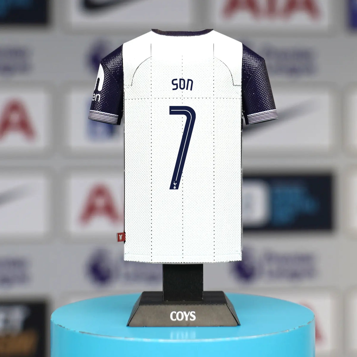 The back of a Tottenham Hotspur white home jersey collectible on a stand, customized with a player's name and the number 7.