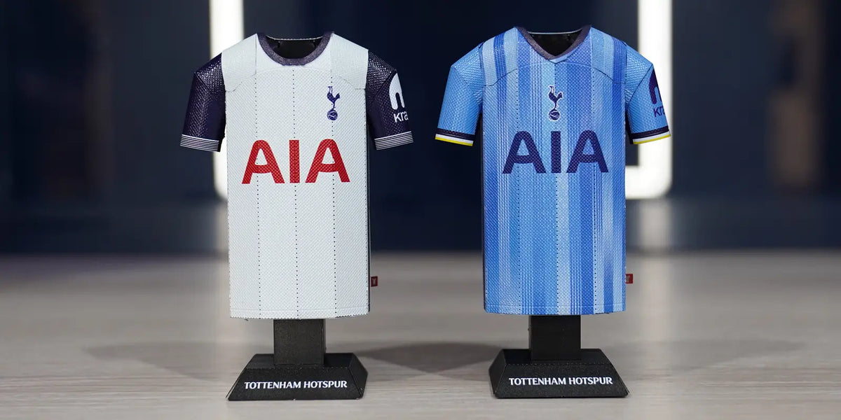 Lifestyle product photograph showcasing both the white home and light blue away Tottenham Hotspur 2024/2025 metal jersey collectibles standing together on display