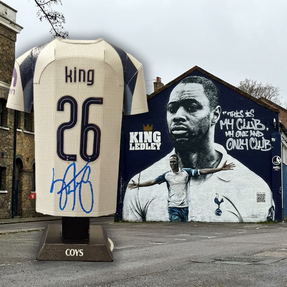 Signed sports jersey with number 26 and name 'King' in front of a mural of a football player with the same name.