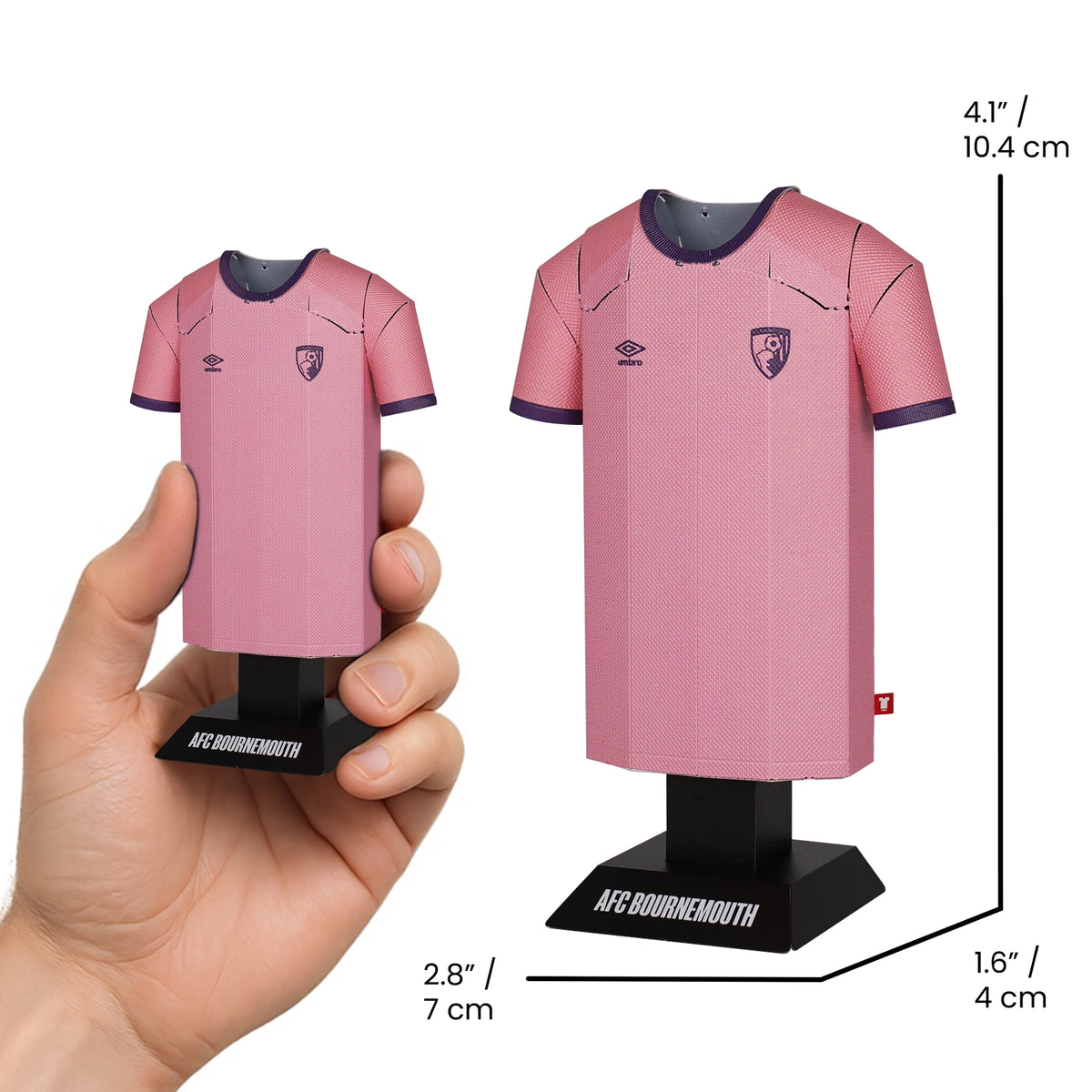 Pink sports jersey model held by a hand with measurements displayed.
