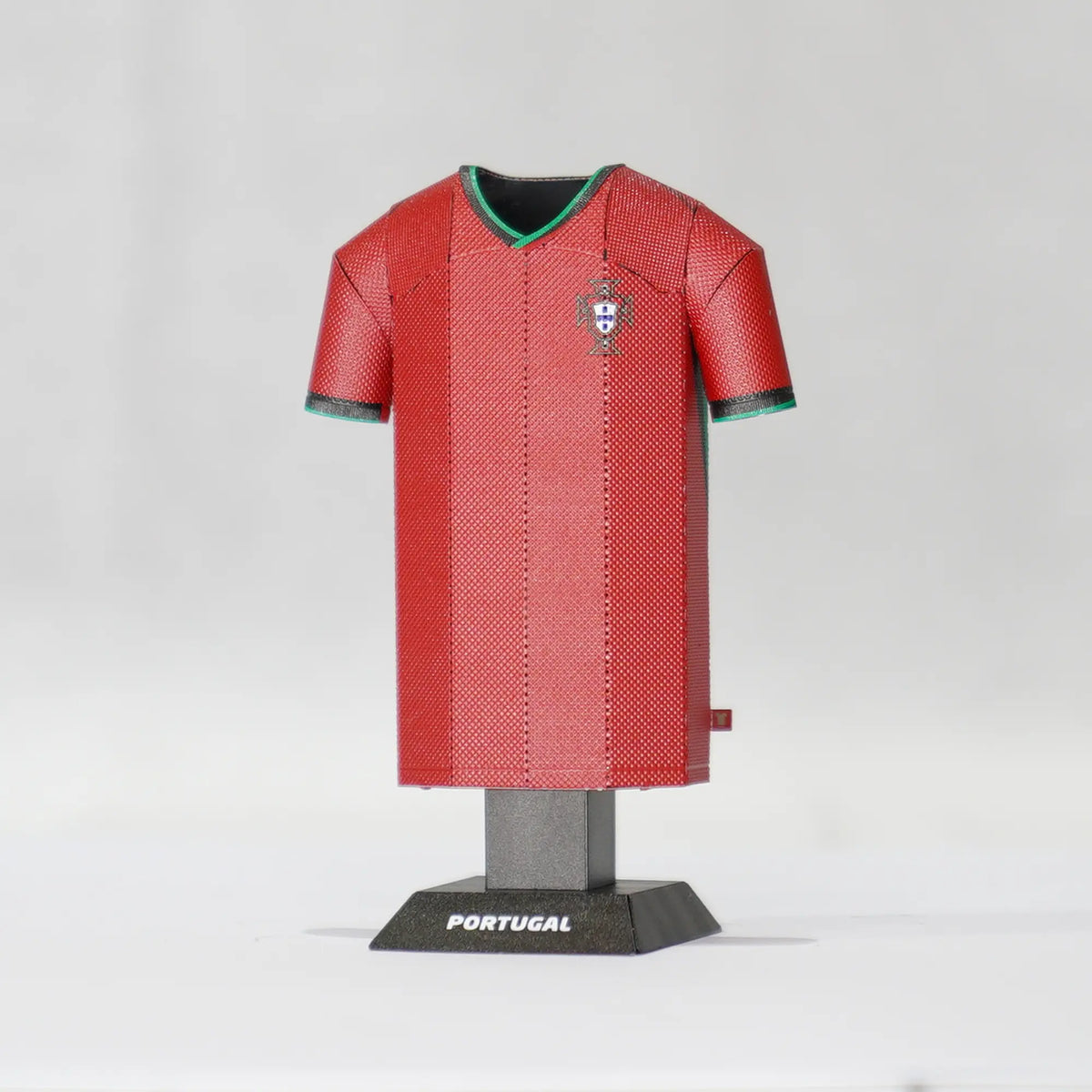 Red soccer jersey on a mannequin with 'Portugal' branding on a white background