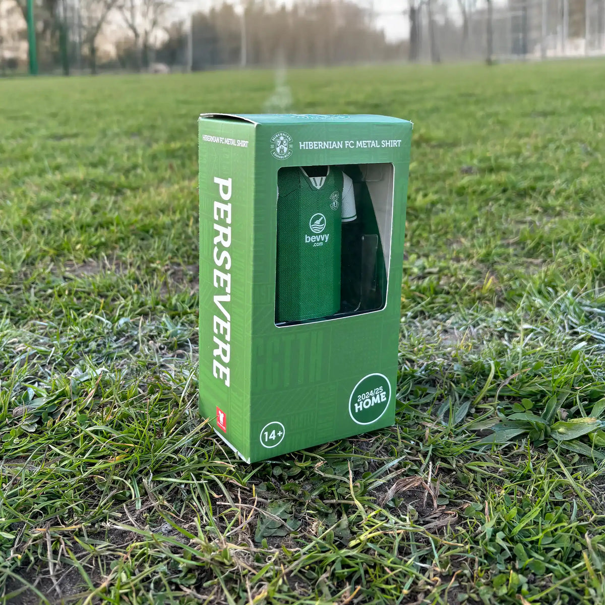 Square lifestyle product photograph showcasing a Hibernian FC premium green display box standing on a surface outdoors.