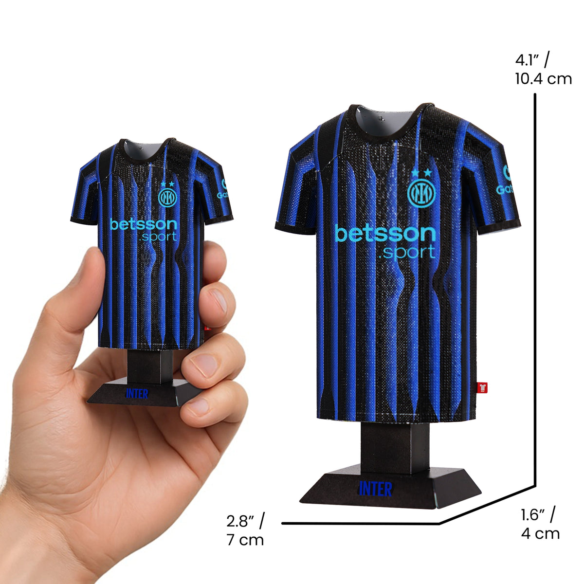 Model of a blue and black sports jersey with 'betsson sport' branding, held by a hand and displayed on a stand.
