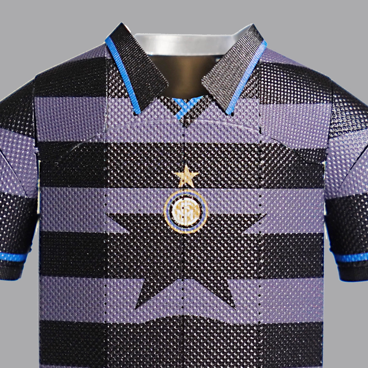 A close-up photograph showcasing the intricate embroidered retro club crest on the chest of an Inter Milan third jersey.