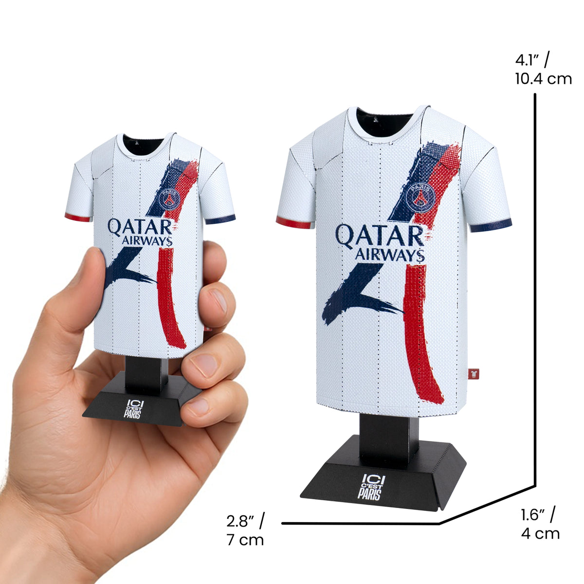 Miniature soccer jersey with Qatar Airways branding held by a hand, displayed on a stand with measurements.