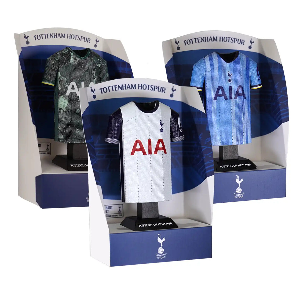 Three Tottenham Hotspur football shirts in display boxes on a white background