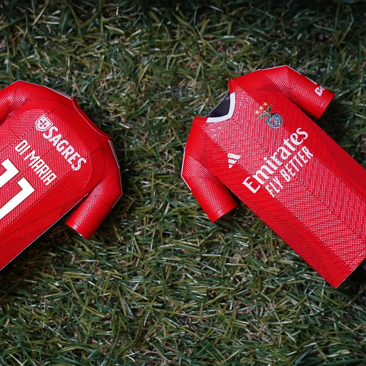 A close-up product photograph highlighting the textured material and fine craftsmanship details on a premium SL Benfica collectible jersey.